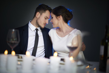 Studio shot of elegant couple having dinner