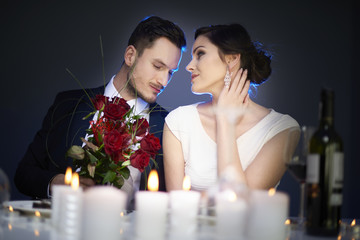Man presenting his parter with bunch of flowers