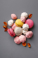 Macarons and meringues on the pink plate. Top view