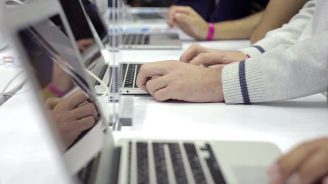 Man Works Behind Laptop Computer