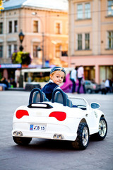 What's up? Charming boy drives little white BMW's cabrio