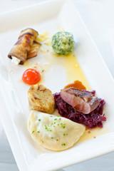 Roast duck, red cabbage roll and dry fruits in fine dining restaurant