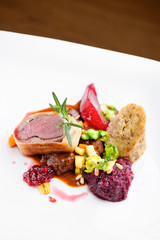 Roast duck, red cabbage roll and dry fruits in fine dining restaurant