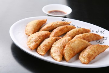 mandu twigim Fried Dumplings on plate