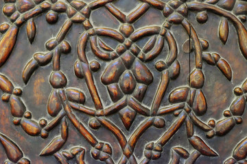 old Central Asian pattern on wooden surface