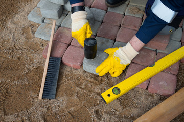 Mason worker making sidewalk pavement