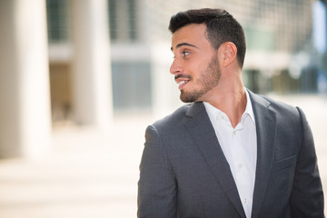 Fototapeta premium Portrait of a smiling businessman looking behind