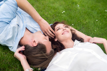 Happy couple relaxing on the grass