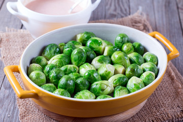 ceramic bowl with brussels sprouts on wooden table