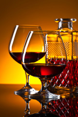  glasses of brandy on the reflective background
