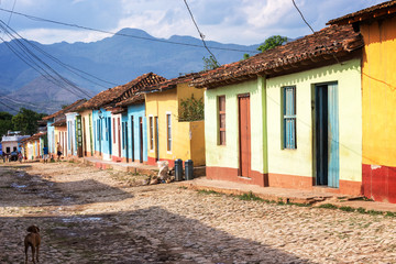 Fototapeta na wymiar Colorful houses in a paved street of Trinidad, Cuba