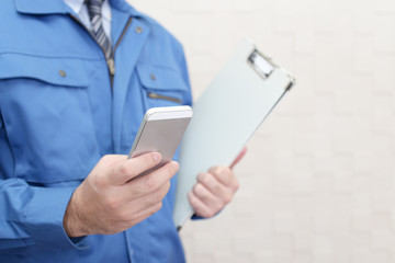 スマートフォンを持つ労働者