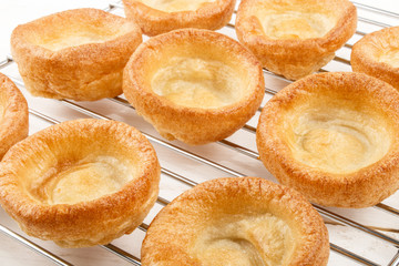 freshly baked yorkshire pudding on a cooling rack