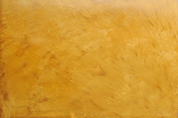 gold decorative plaster imitating marble surface