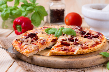 Delicious fresh pizza on brown wooden background