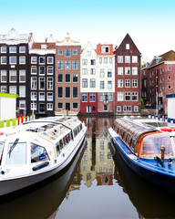 Amsterdam traditional houses on the Damrak canal with typical bo