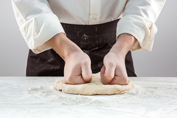 Hands kneading a dough