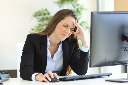 Businesswoman suffering headache