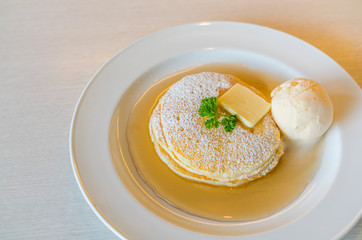 Pancake  with ice cream on table .