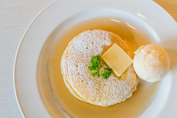 Pancake  with ice cream on table .