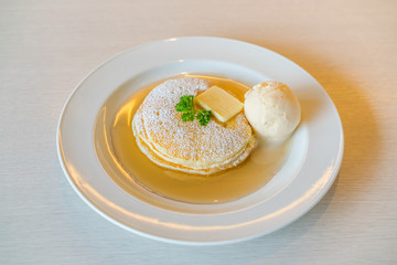 Pancake  with ice cream on table .