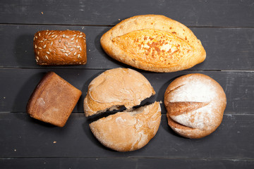 Homemade bread on a black wooden background