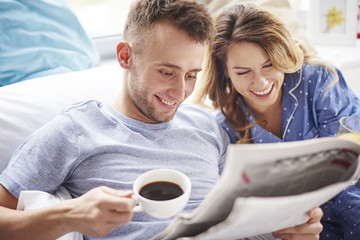 Morning news on the paper makes couple laugh