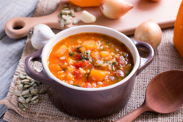 Pumpkin soup with spices on a wooden table