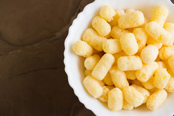 Sweet corn sticks in a white bowl. Tasty dessert.
