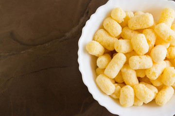 Sweet corn sticks in a white bowl. Tasty dessert.