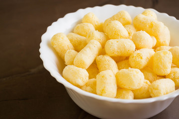 Sweet corn sticks in a white bowl. Tasty dessert.