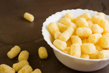 Sweet corn sticks in a white bowl. Tasty dessert.