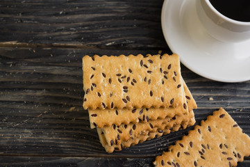 Crackers with sesame seeds on a wooden table in rustic style