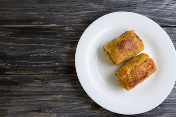 Fried pancakes with meat on a white plate