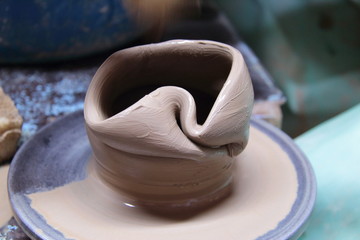 Clay pot on a pottery wheel