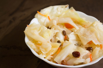 Sauerkraut in a white bowl. Delicious and healthy dishes.