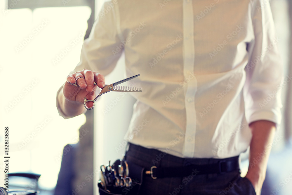 Poster close up of male stylist with scissors at salon