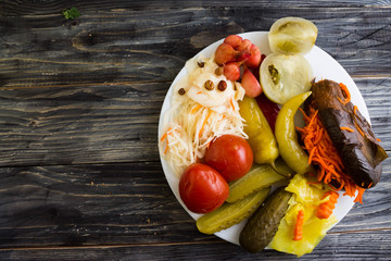 Pickled vegetables on a white plate in a rustic style