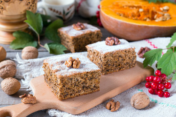 Pumpkin cake with nuts on wooden table