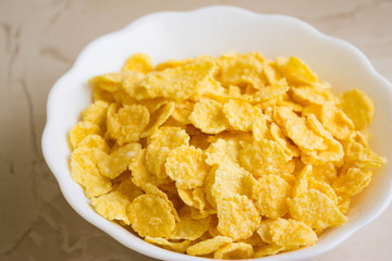 Cornflakes in a white bowl. A hearty and delicious breakfast.