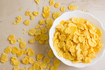 Cornflakes in a white bowl. A hearty and delicious breakfast.