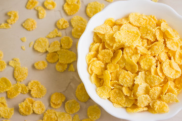 Cornflakes in a white bowl. A hearty and delicious breakfast.