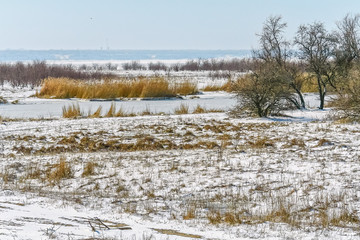 Winter landscape with snow-covered banks of the river