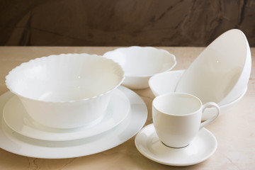 Various white dishware on a marble background