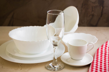 Various white dishware on a marble background