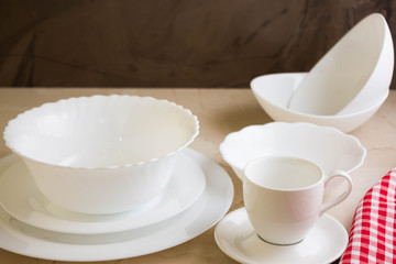 Various white dishware on a marble background