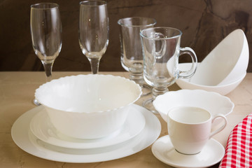 Various white dishware on a marble background