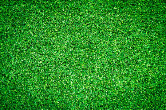 Green grass texture, grass background for design with copy space for text or image. Top view of artificial green grass for golf course and soccer field.