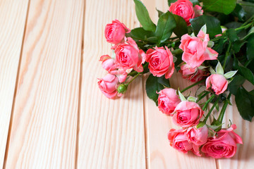 Beautiful roses on a wooden background