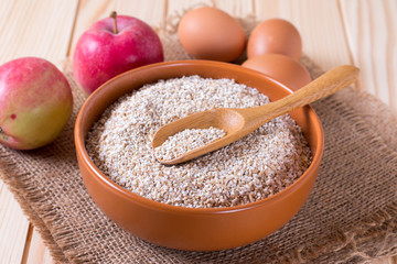 Dry Raw Rye Grain in a bowl with a spoon with eggs